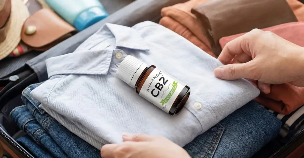 A bottle of CB2 Wellness packed in a suitcase